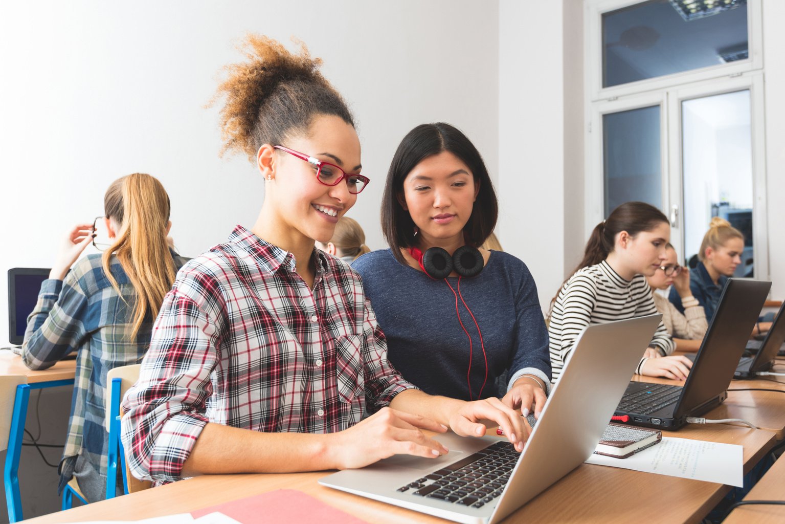 Young women learning computer programming